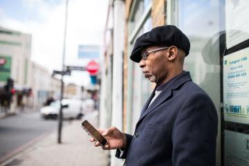 Man standing outside looking at his phone