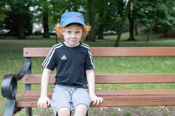 Young boy sitting on a bench