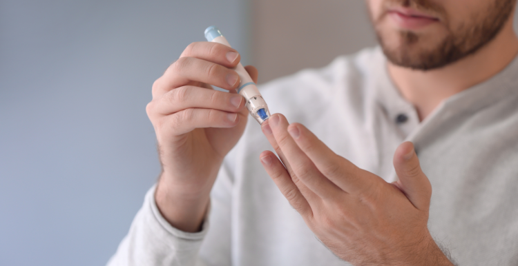 Young male doing a blood finger prick test 