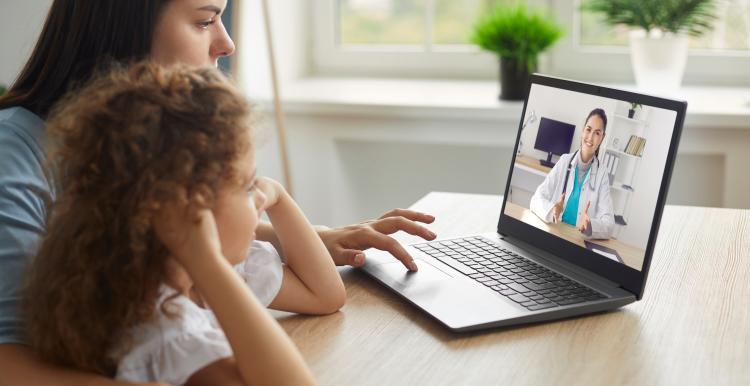 Mother and child having a telemedicine consultation with remote doctor