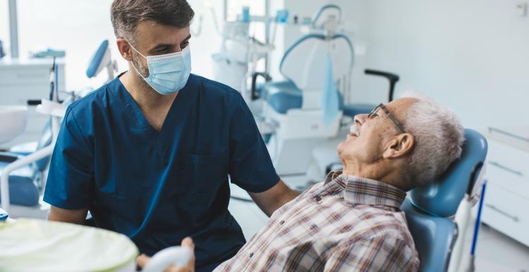 Senior patient sitting in a dental chair whilst waiting for a check up. 