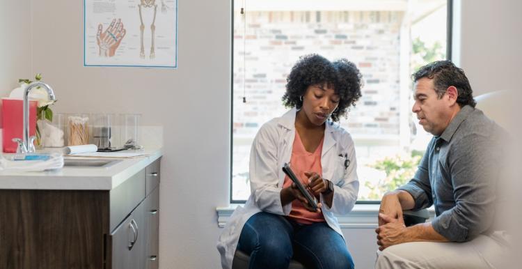A female doctor showing a patient some written information 
