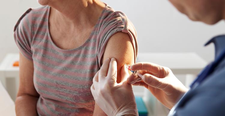 A healthcare professional providing a vaccine to a patient