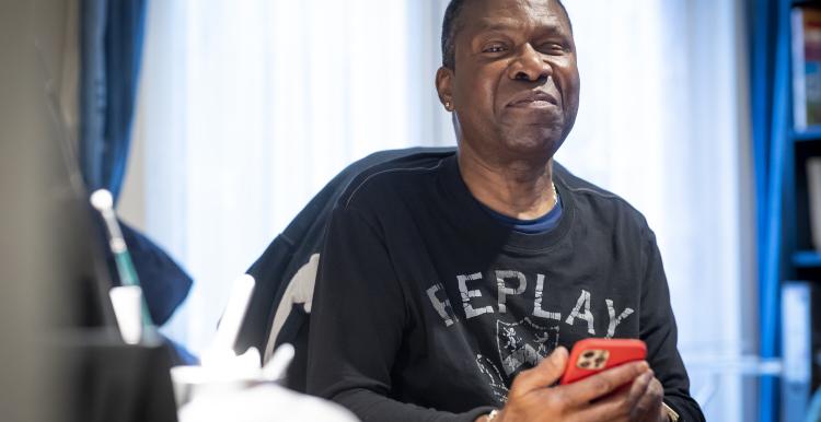 A man in his study using his smartphone