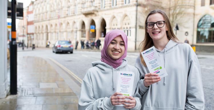 Two young female volunteers promoting Healthwatch