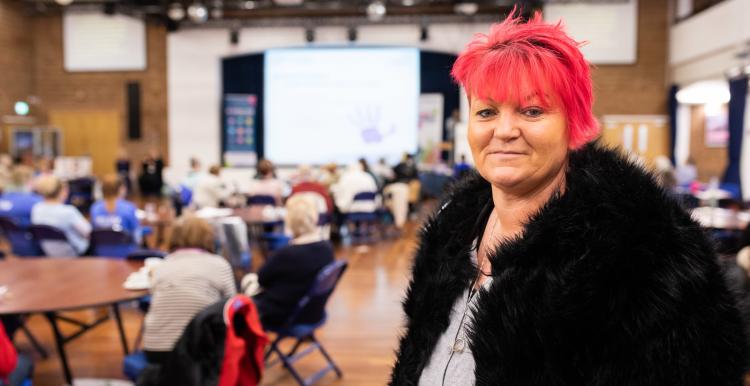 Woman with pink hair at a Healthwatch meeting