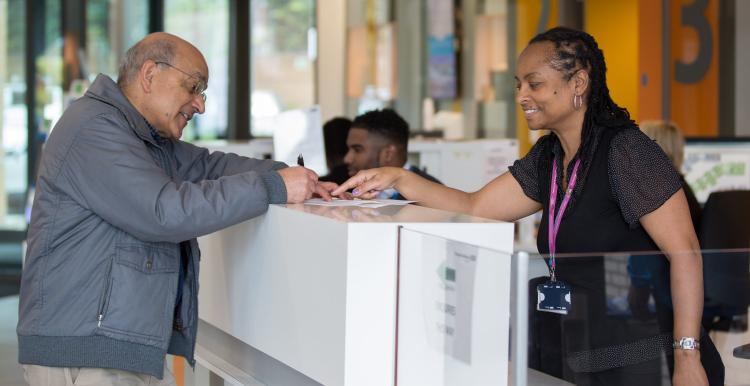 Patient speaking to a receptionist