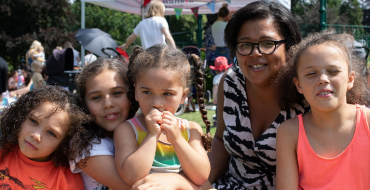 A woman with 4 children at a picnic