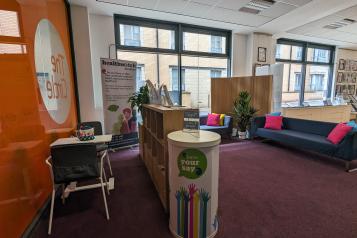 Photo of the Healthwatch Hub located on the ground floor of the Circle; the photo shows some sofas in the waiting area and the small table used for consultations