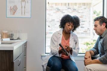 A female doctor showing a patient some written information 