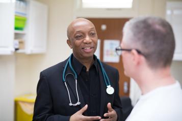 Male doctor speaking to a male patient