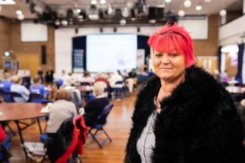 Woman with pink hair at a Healthwatch meeting