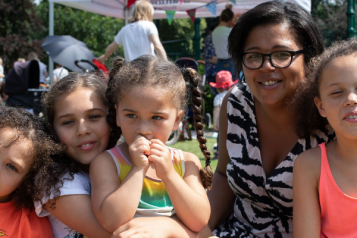 A woman with 4 children at a picnic