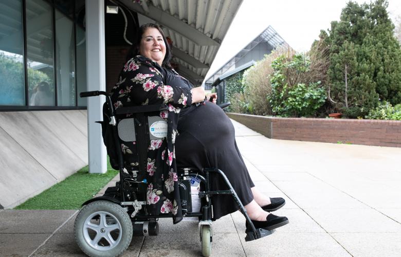 Woman in electric wheelchair smiling