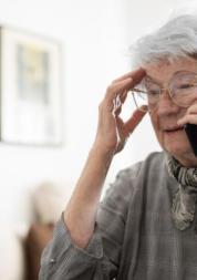 Older lady expressing concerns on the phone. 
