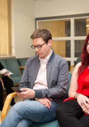 Two people sitting in a waiting room