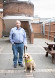 man with guide dog
