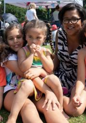 Family sitting in a park together at a Healthwatch event